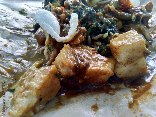 Rujak uleg, traditional East Javanese food, (indonesian food, asia) with kerupuk. Indonesian salad with peanut sauce. photo