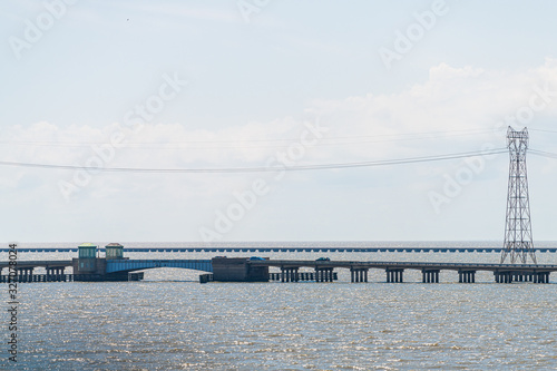 Slidell, USA highway road bridge with traffic near New Orleans with power lines, horizon and Lake Pontchartrain estuary photo