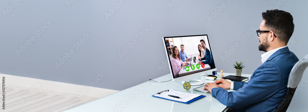 Businessman Video Conferencing With Coworkers - obrazy, fototapety, plakaty 