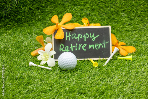 Golf retirement with golf ball and tee with flowers are on green grass