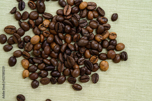 Coffee beans isolated on background with space for text. Roasted coffee beans as background. Flat lay, top view, clode up photo