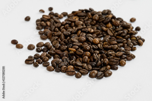 Fototapeta Naklejka Na Ścianę i Meble -  Coffee beans isolated on white background background with space for text. Roasted coffee beans as background. Flat lay, top view, copy space. Close up