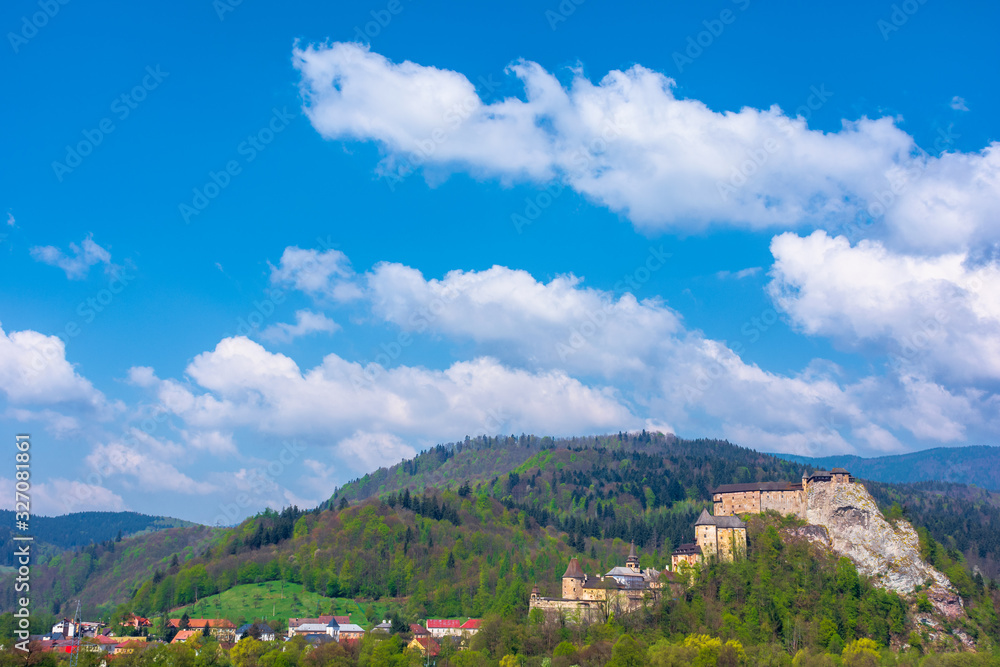 orava castle of slovakia. medieval fortress on a hill in a beautiful place in mountains. wonderful sunny weather with fluffy clouds in springtime