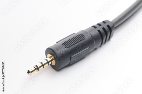 Audio video adapter cable with trrs jack to trs connectors on a white background photo