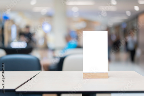 Wallpaper Mural Mock up Label the blank menu frame in Bar restaurant ,Stand for booklets with white sheets paper acrylic tent card on wooden table cafeteria blurred background can inserting the text of the customer. Torontodigital.ca