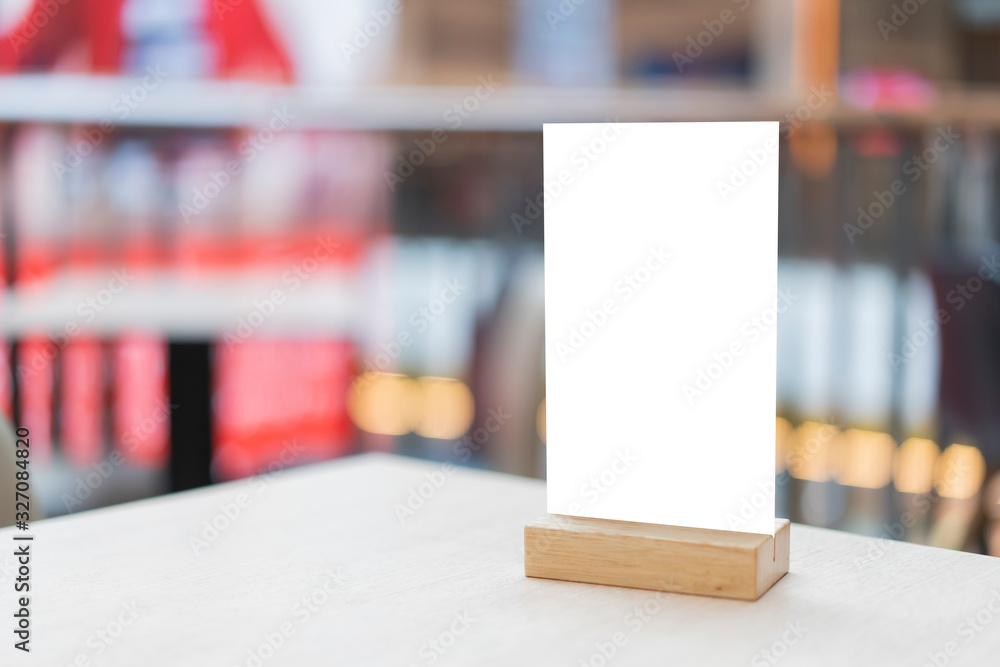 Mock up Label the blank menu frame in Bar restaurant ,Stand for booklets with white sheets paper acrylic tent card on wooden table cafeteria blurred background can inserting the text of the customer. Mock up Label the blank menu frame in Bar restaurant ,Stand for booklets with white sheets paper acrylic tent card on wooden table cafeteria blurred background can inserting the text of the customer.