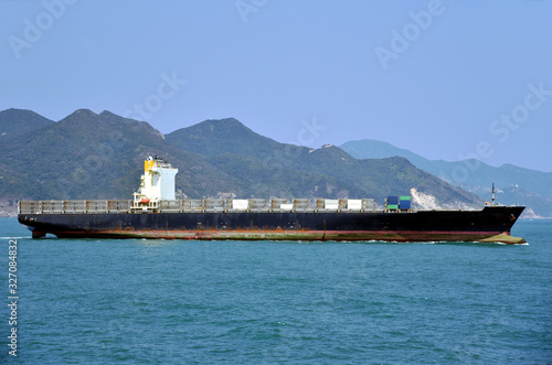 Cargo container ship departing from the port of Yantian, China. She has no cargo on deck. 