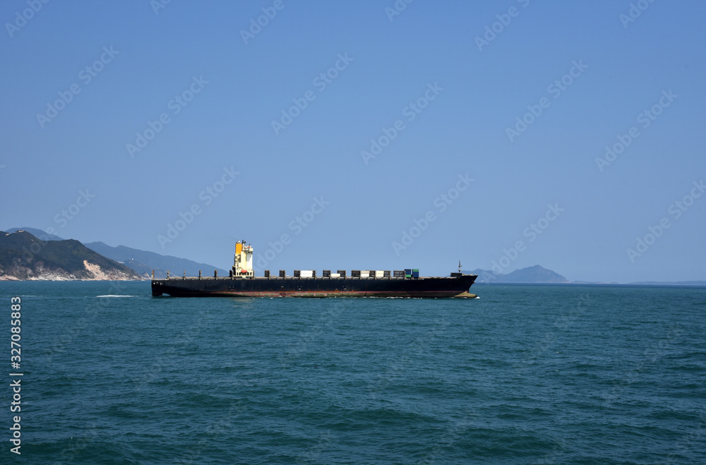 Cargo container ship departing from the port of Yantian, China. She has no cargo on deck. 