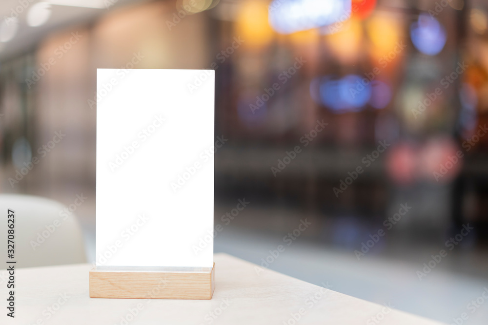 Mock up Label the blank menu frame in Bar restaurant ,Stand for booklets with white sheets paper acrylic tent card on wooden table cafeteria blurred background can inserting the text of the customer. Mock up Label the blank menu frame in Bar restaurant ,Stand for booklets with white sheets paper acrylic tent card on wooden table cafeteria blurred background can inserting the text of the customer.