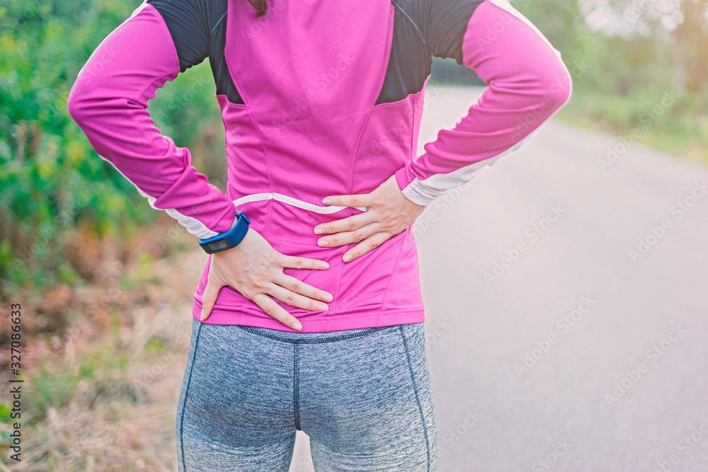 sport runner woman cramps in back and feel pain, athletic young Asian