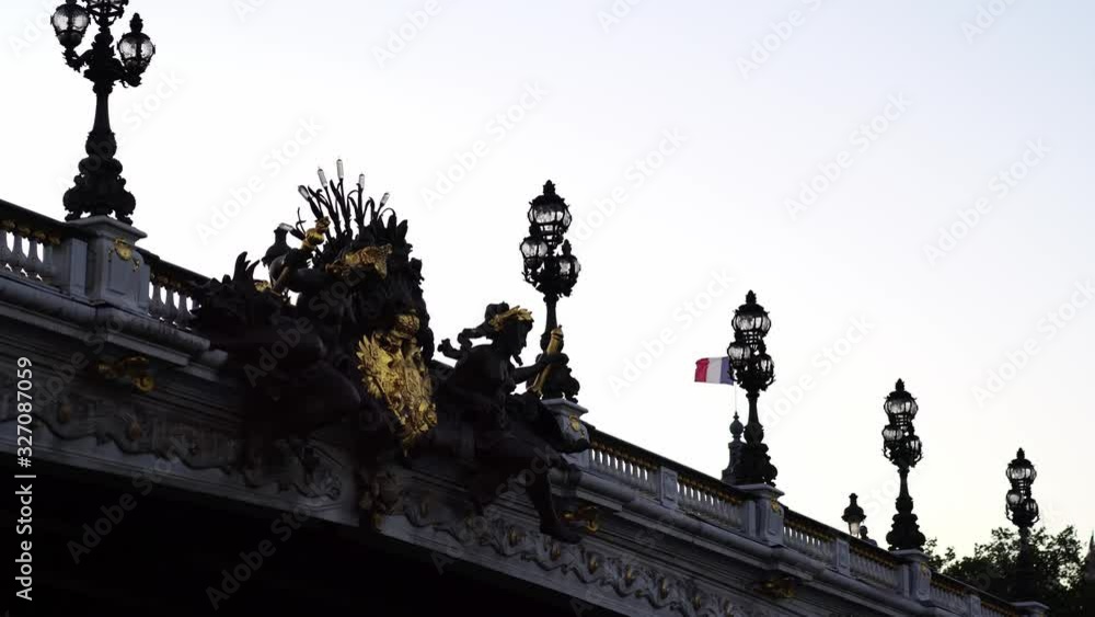 French flag on Grand Palais building. Alexander III bridge on Seine river. Paris tourism attraction & famous landmark. Romantic honeymoon travel destination. French flag on Grand Palais building. Alexander III bridge on Seine river. Paris tourism attraction & famous landmark. Romantic honeymoon travel destination.