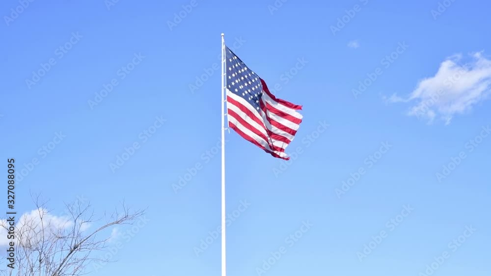 USA flag waving on blue sky background. USA flag waving on blue sky background.