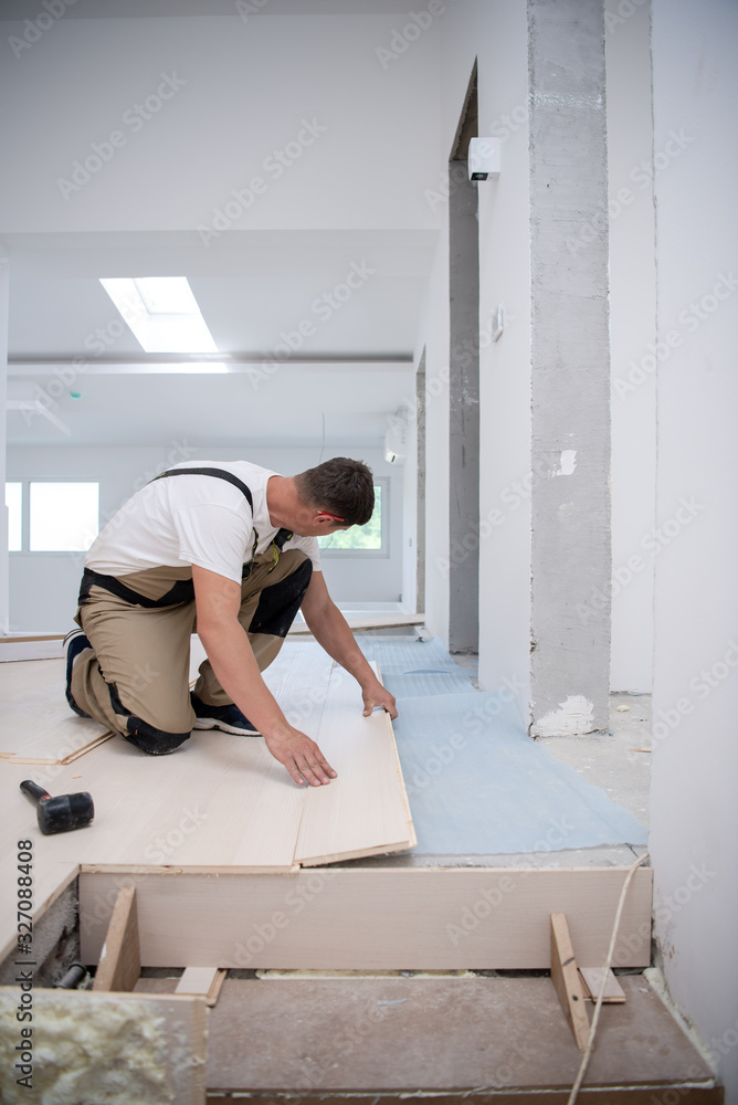 Worker Installing New Laminated Wooden Floor