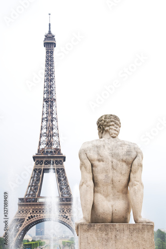 Statue of man with Eiffel tower and the fountain in Paris, France