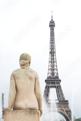 Statue of woman with Eiffel tower and the fountain in Paris, France