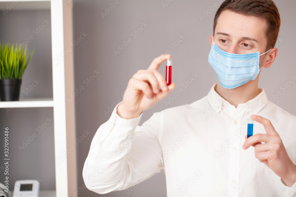 Young doctor holding test tubes with virus tests. Young doctor holding test tubes with virus tests.