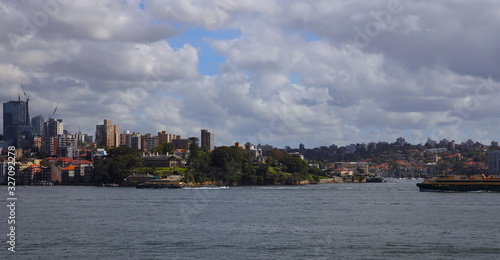 Panorama Sydney Harbour bridge and forshore viewed from Botanical Gardens in NSW Australia on a nice sunny and partly cloudy Morning blue skies