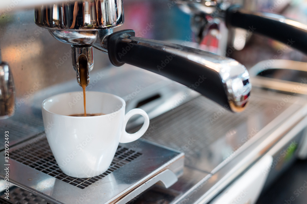 black coffee in white cup on coffee maker black coffee in white cup on coffee maker