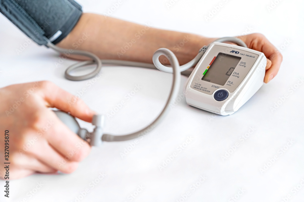 Blood pressure measurement. A woman's hand and a device for measuring pressure. Blood pressure measurement. A woman's hand and a device for measuring pressure.
