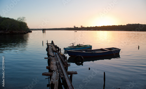 rustic dock in cienfuegos bay at sunset