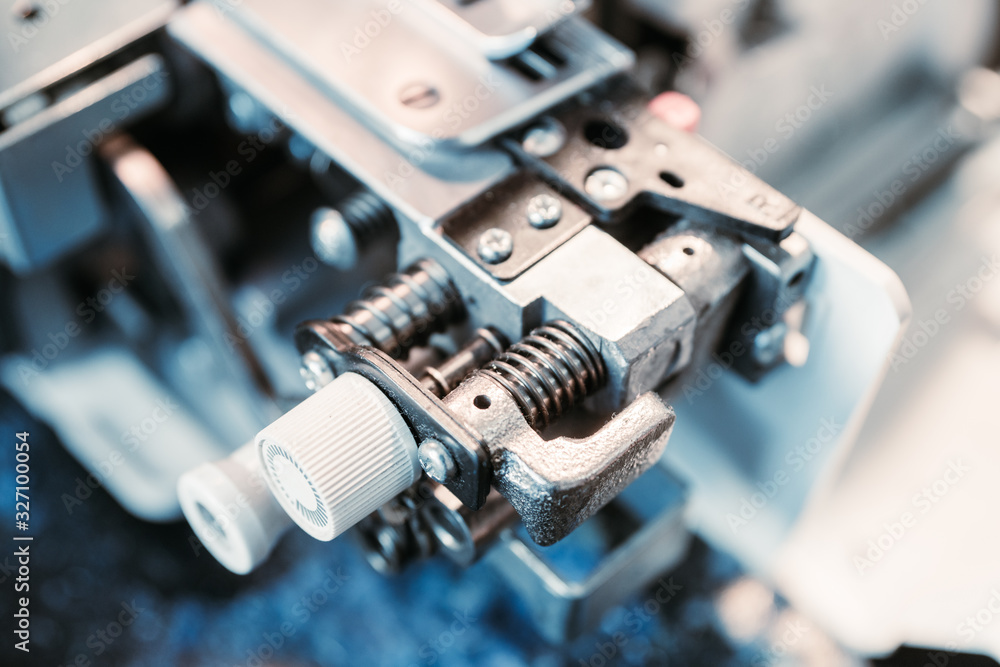 Fototapeta premium Modern sewing machine (overlock) macro shot. Selective focus. Shallow depth of field.