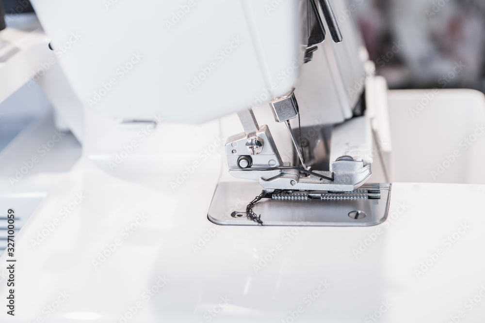 Modern sewing machine (overlock) macro shot. Selective focus. Shallow depth of field.