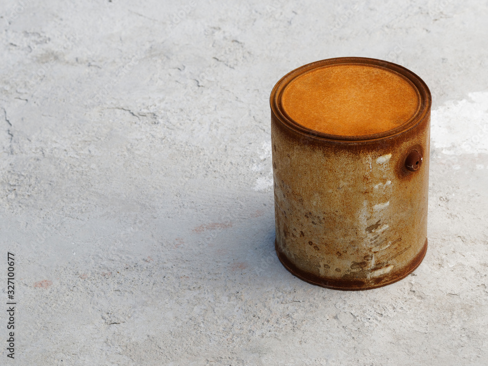 A rusty can of paint on concrete. Copy space.