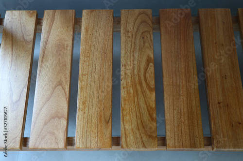 Light brown wooden rack. Row of wood