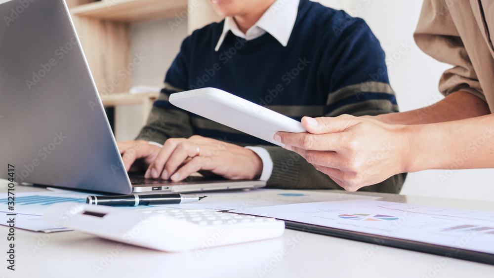 Working together on project, Two young business colleagues working or meeting with partner discussing financial documents and idea. Working together on project, Two young business colleagues working or meeting with partner discussing financial documents and idea.