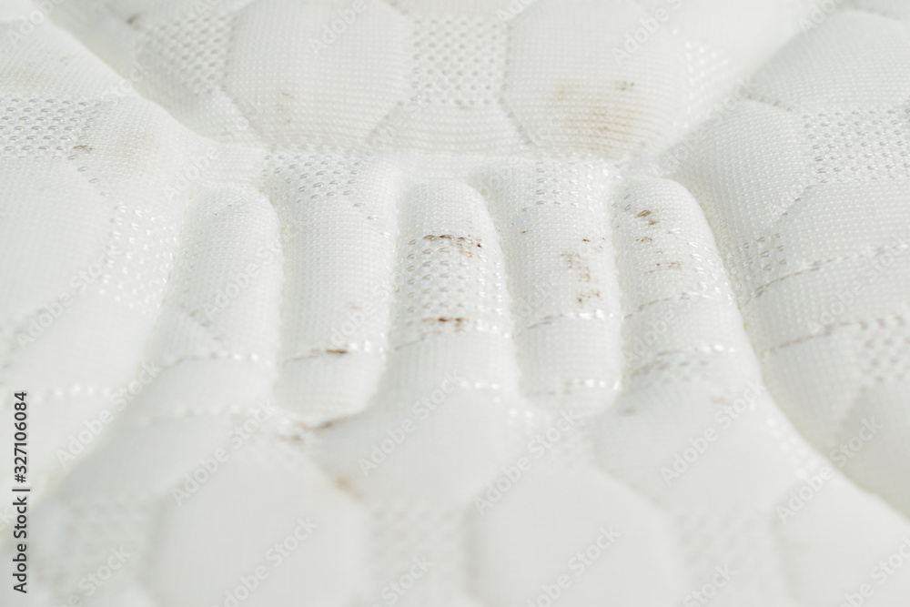 Mold on a mattress. Black stains on a white fabric. Mold on a mattress. Black stains on a white fabric.