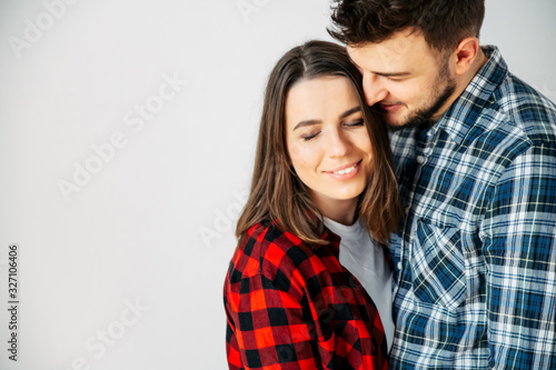 Couple in love cuddling on a white background