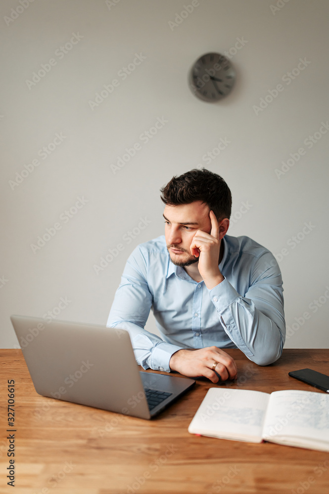 An office worker in a shirt is carefully thinking An office worker in a shirt is carefully thinking