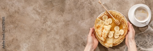 Delicious homemade pancakes with honey on a textural background. Top view, close-up. Traditional holiday celebration concept. Russian translation wide and happy Shrovetide Maslenitsa.
