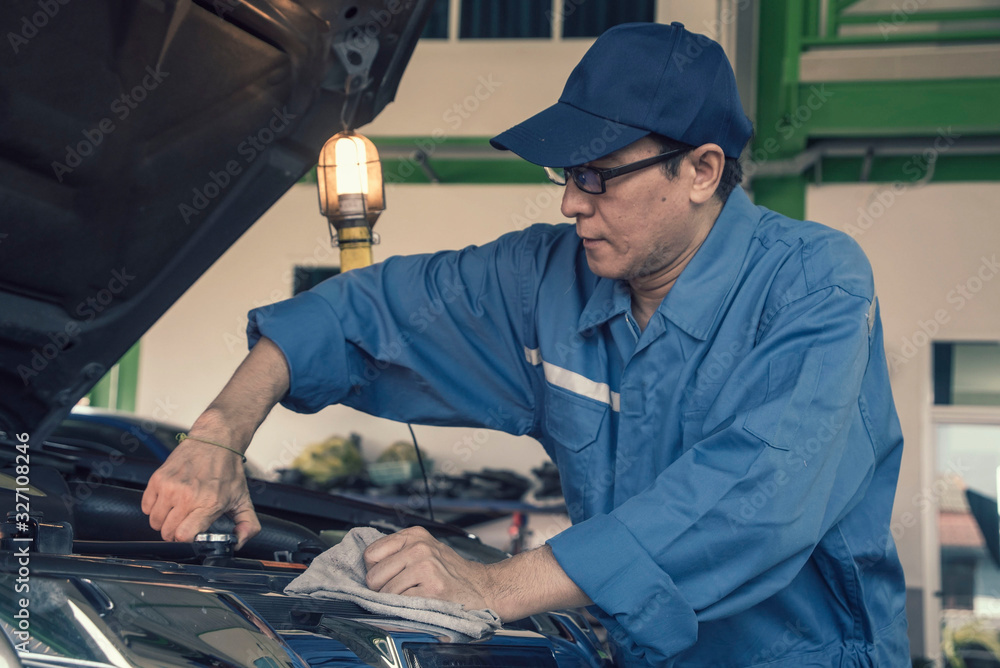Engineer mechanics working on a vehicle in a garage or service workshop, Service and maintenance vehicle concept Engineer mechanics working on a vehicle in a garage or service workshop, Service and maintenance vehicle concept