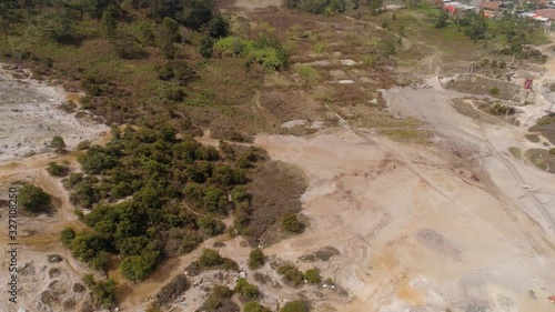 plateau with volcanic activity, mud volcano Kawah Sikidang, geothermal activity and geysers. aerial view volcanic landscape Dieng Plateau, Indonesia. Famous tourist destination of Sikidang Crater it photo