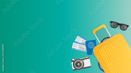 Green background with place for text. Yellow suitcase, world map, sun glasses, passport and tickets. Background for the theme of leisure and tourism. 