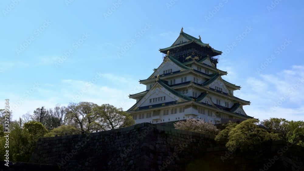4K, Main tower of Osaka Japanese Castle behind rock wall, famous landmarks in Japan. Beautiful scene of the old heritage building Japanese.-Dan 4K, Main tower of Osaka Japanese Castle behind rock wall, famous landmarks in Japan. Beautiful scene of the old heritage building Japanese.-Dan