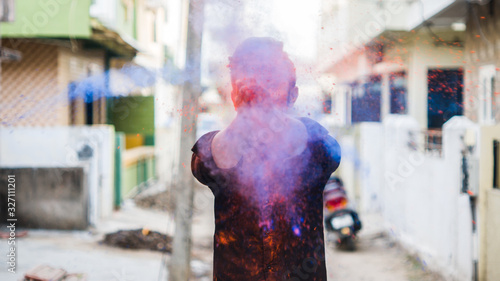 Young man in holi colors. holi is a festival of India. It is festival of colors and Joy. It is also called as Dhuleti. photo