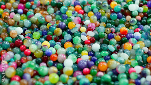 Colourful beads scattered throughout the background texture. Pattern, Decoration, Wallpaper.
