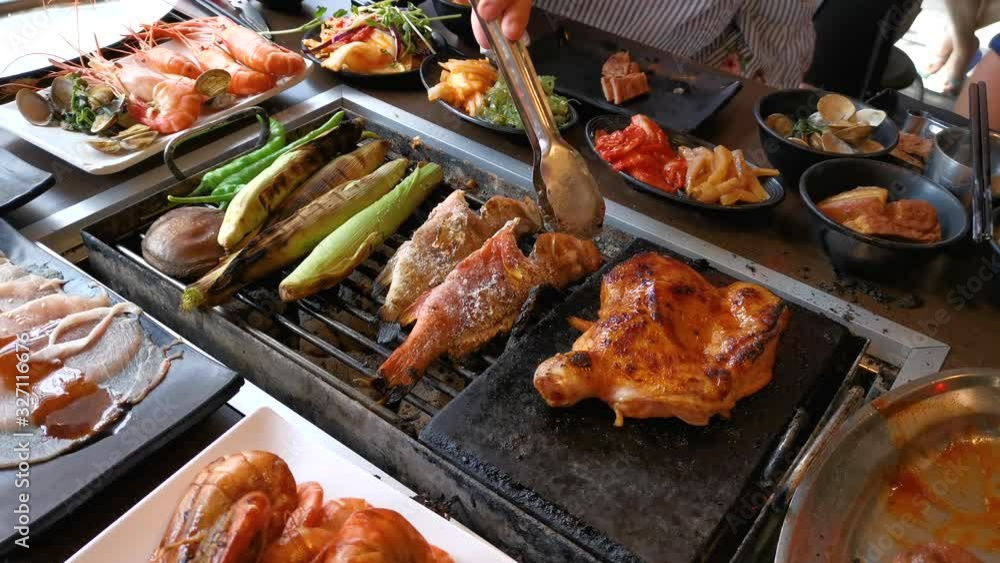BBQ chicken and seafood on grill at restaurant BBQ chicken and seafood on grill at restaurant