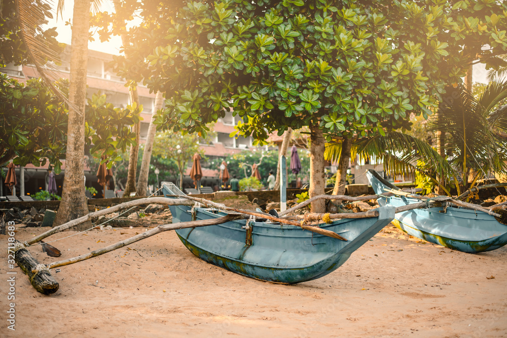 traditional fishing boat on sandy beach in Hikkaduwa Sri Lanka