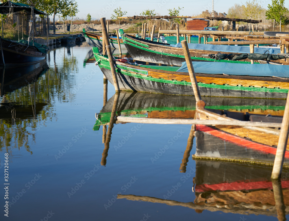 Fototapeta premium reflection of boats docked in a pond
