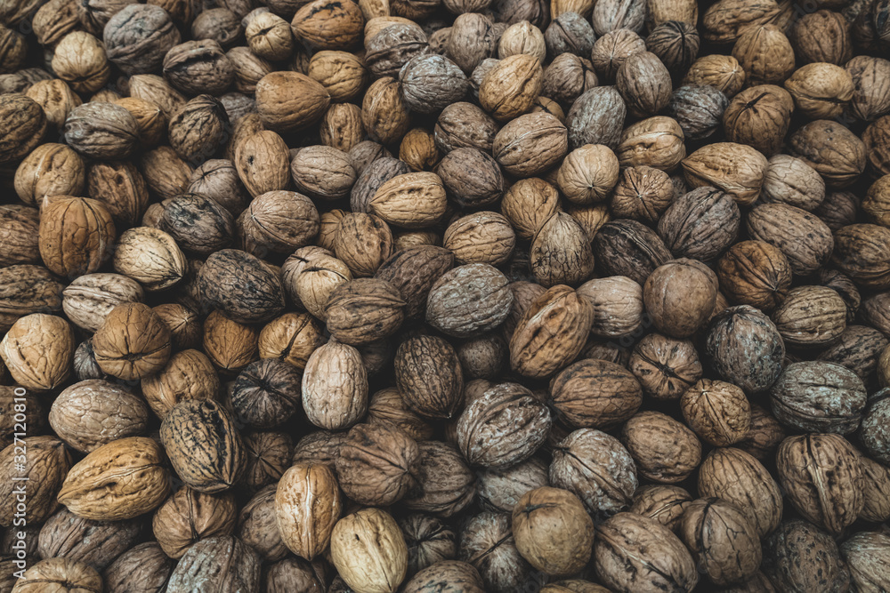 Natural in shell walnuts background Natural in shell walnuts background
