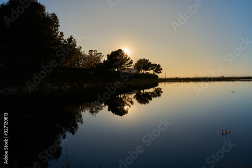Fototapeta Naklejka Na Ścianę i Meble -  sunset over a water pond                     