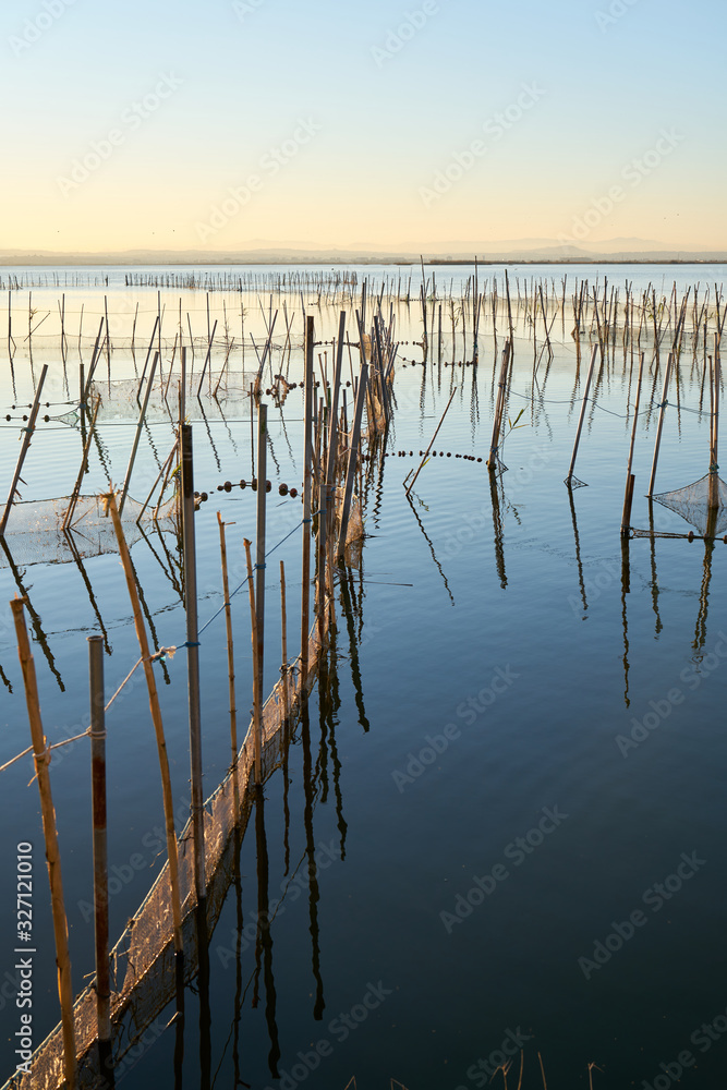 the sunset with fishing nets on a lake the sunset with fishing nets on a lake