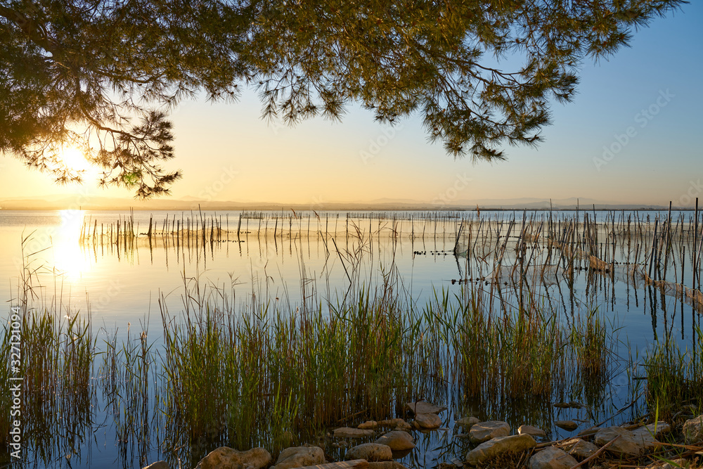 the sunset with fishing nets on a lake the sunset with fishing nets on a lake