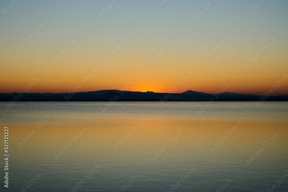 orange sunset on a lake orange sunset on a lake