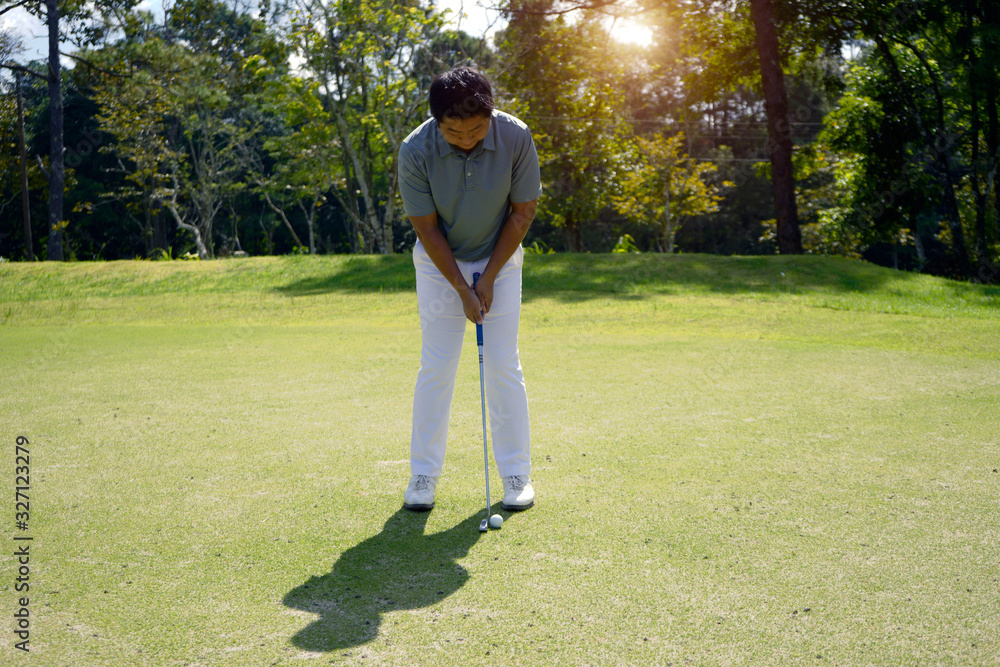 Golfer putting golf ball on the green golf. Golfer putting golf ball on the green golf.