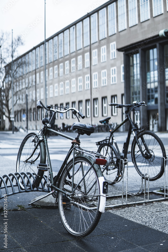 vertical shot of vintage bicycles in front of university building in Cologne, Germany