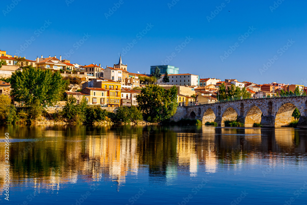 Old stone bridge of Zamora and the old town view with the Douro river. Spain